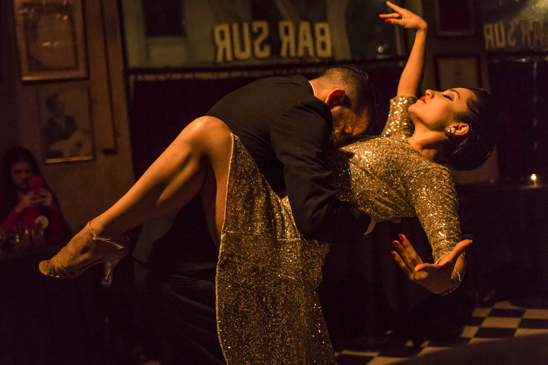 Tango dancers during a live performance in bar.