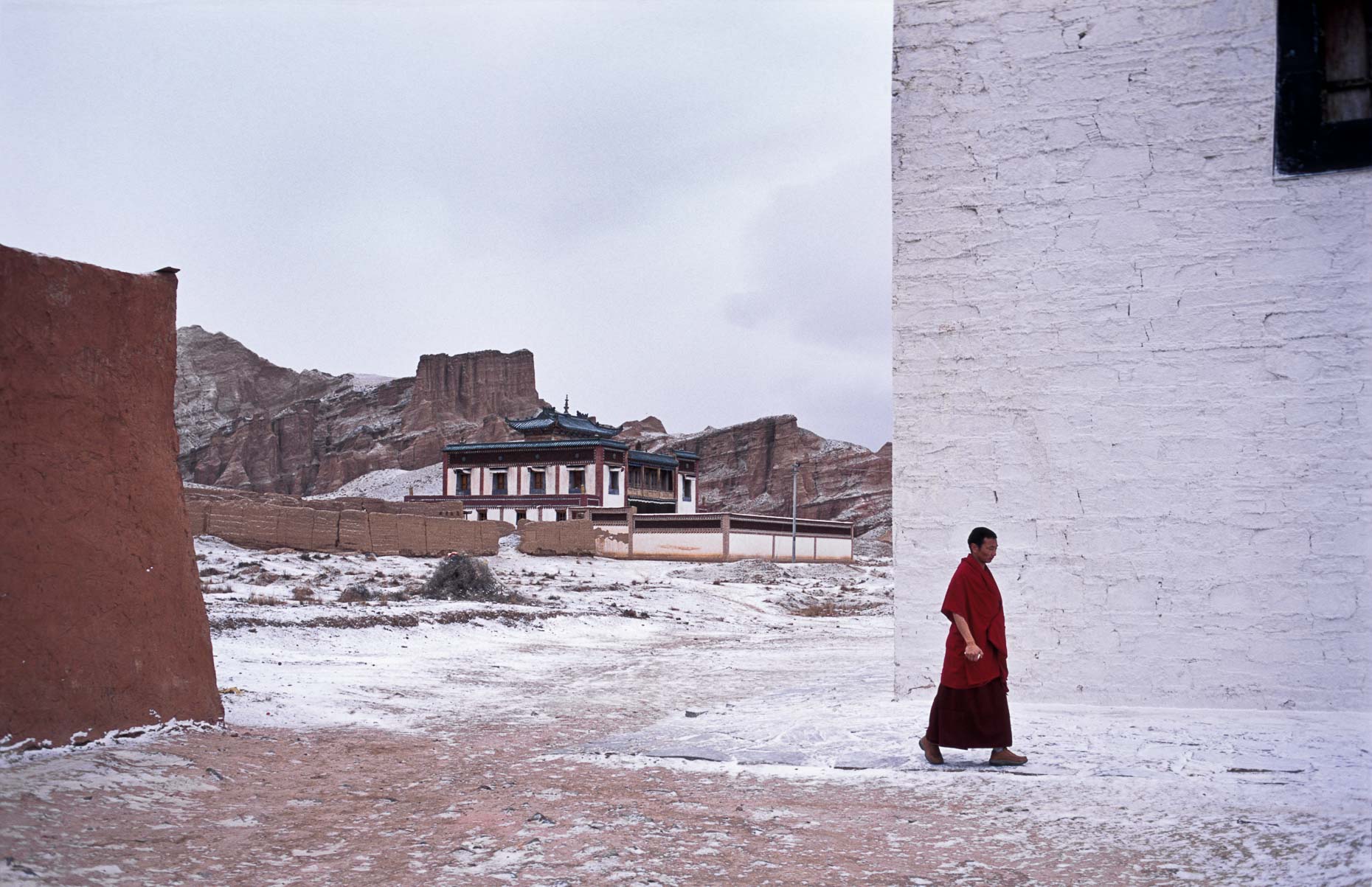 Tibetan buddihist monk walks through monastery 